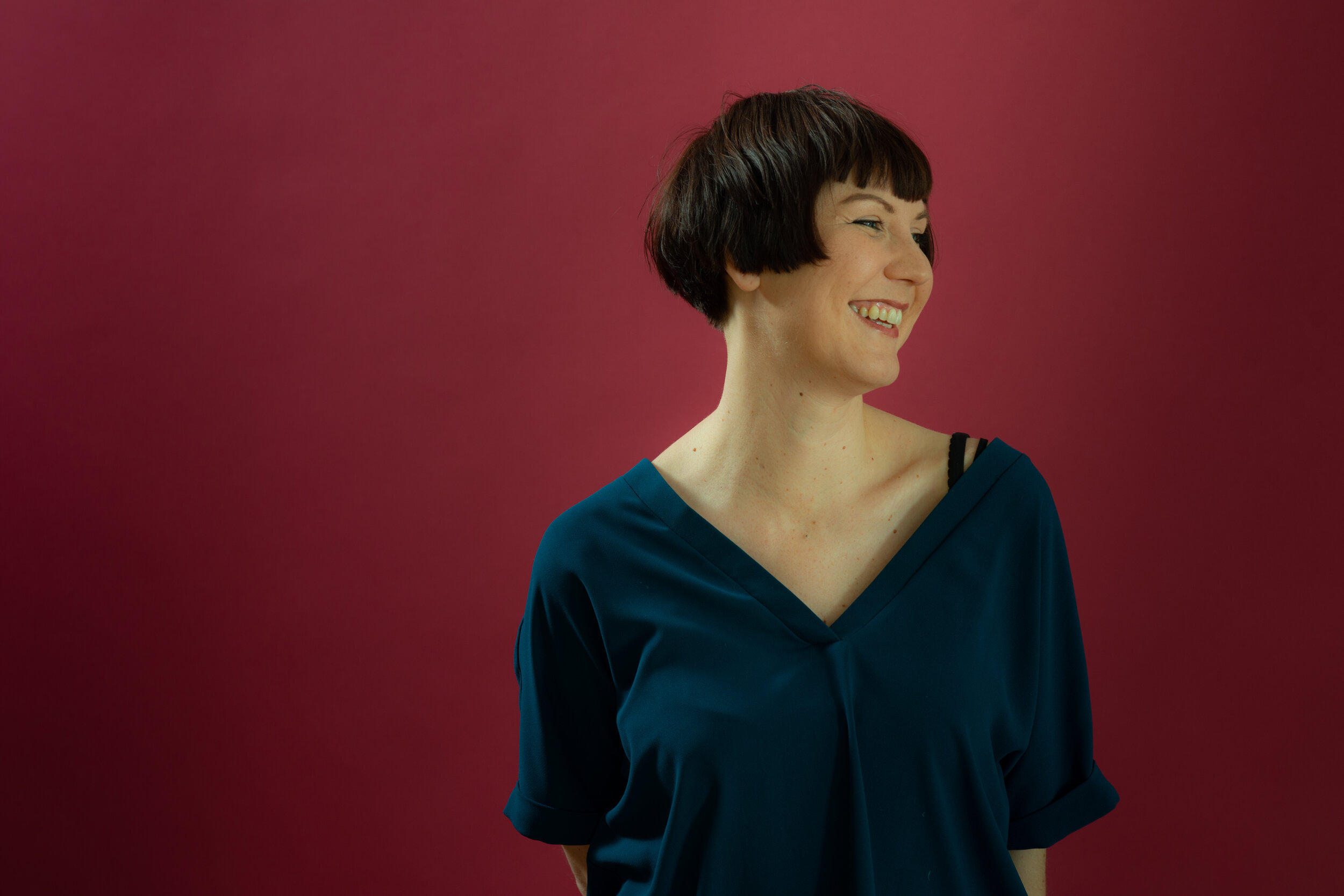 White woman with short brown hair smiles.